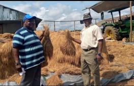Acting Minister and Deputy Minister for Planning and Development Prof. Robert Fagans(R) with the farmer(L)
